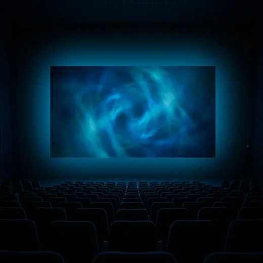 A cinema auditorium facing a bright screen, films on demand
